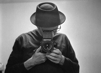 Self-portrait of Marek Majewski holding a medium format camera